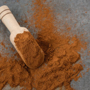 Kayu manis bubuk or cinnamon powder on wooden spoon