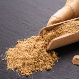 Ginger root on a dark stone background.